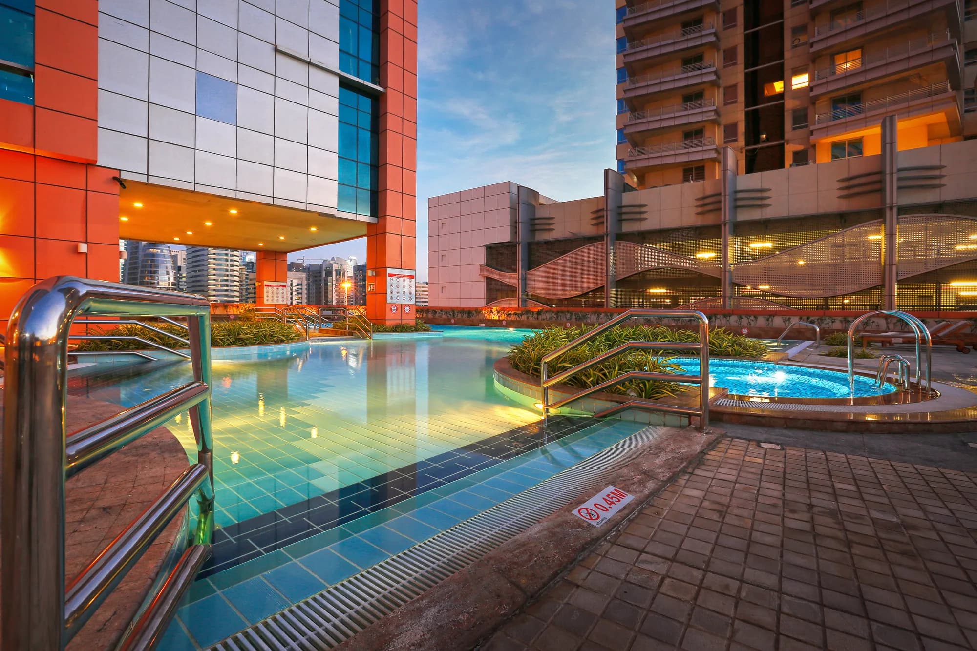 The swimming pool deck at Dubai Jewel Tower at dusk